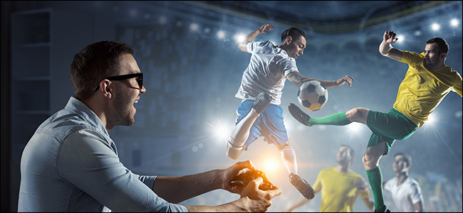Um jogador controla um jogo de futebol real com o controle do Xbox.