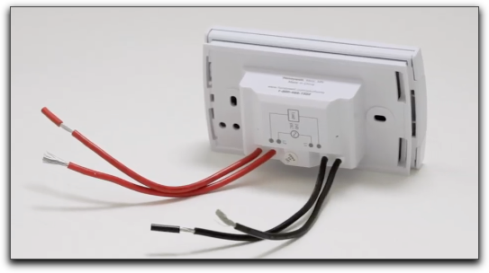 Um termostato de alta tensão típico com 2-4 fios pretos e vermelhos.