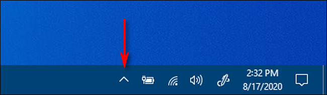 Clique na seta em forma de quilate na área de notificação da barra de tarefas para ver os ícones ocultos no Windows 10.