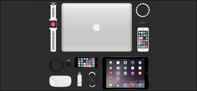 Um MacBook, iPad, Apple Watch, vários iPhones e outros acessórios da Apple em uma mesa.