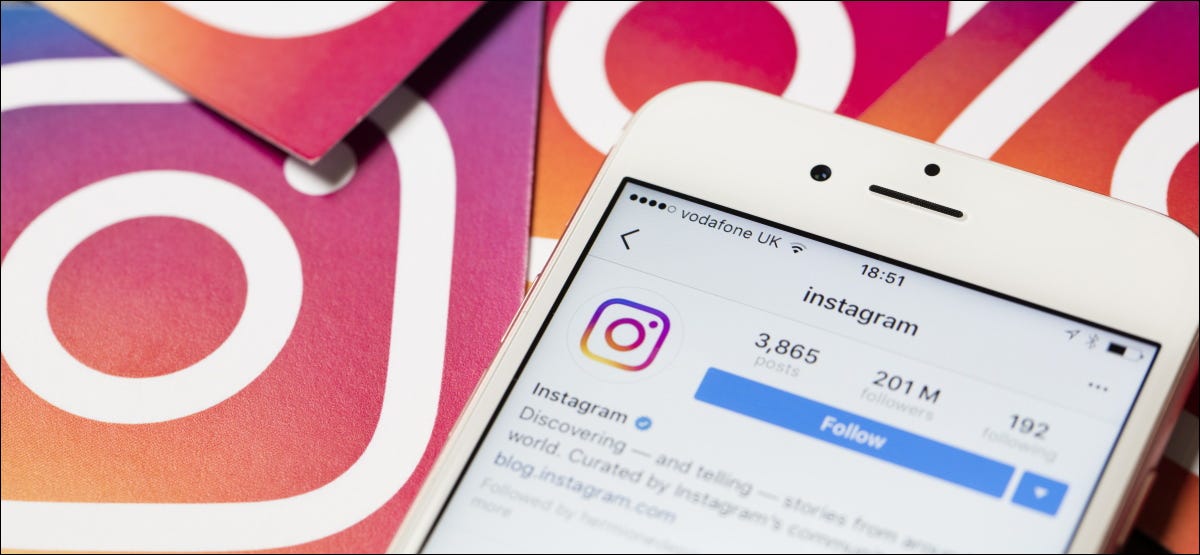 Instagram em um iPhone com logotipos do Instagram em segundo plano.