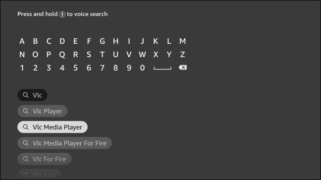 Digite "VLC" usando o teclado na tela.  Realce o "VLC Media Player" nos resultados da pesquisa e pressione o botão central para selecioná-lo.