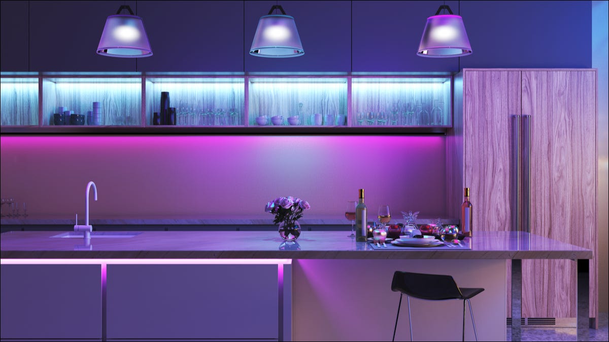kitchen area with light blue and pink lighting