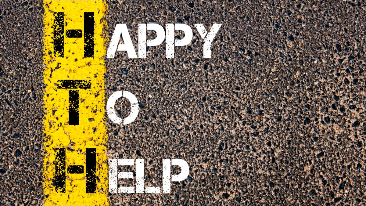 "Feliz em ajudar" pintado em uma estrada de asfalto