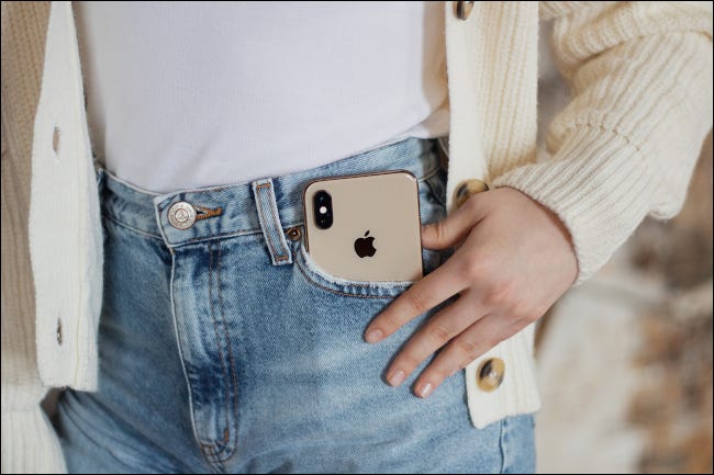 iPhone XS Gold no bolso jeans de uma menina