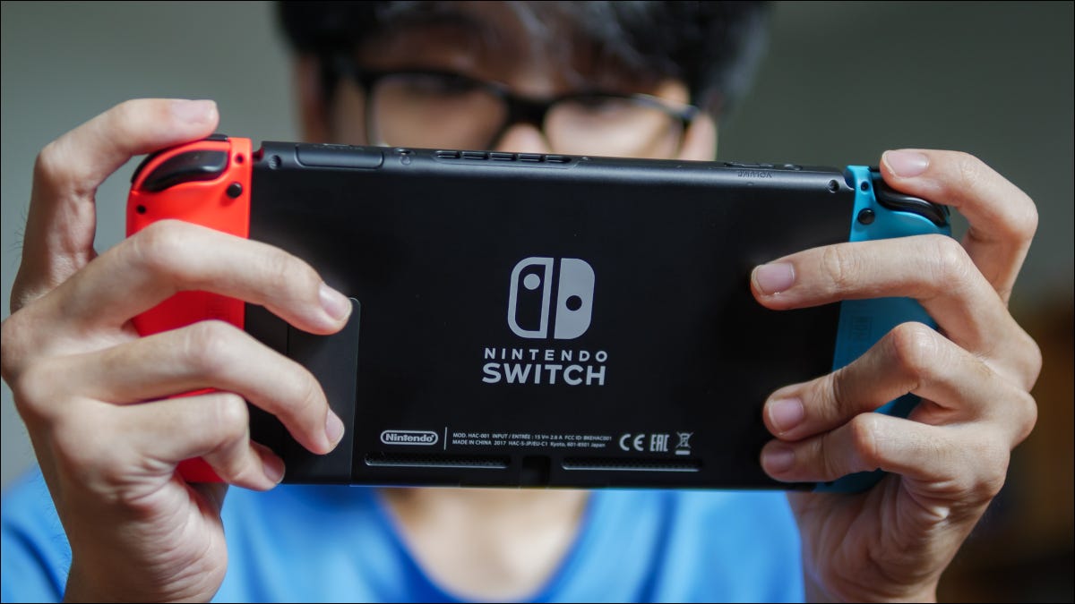 A man playing a Nintendo Switch.