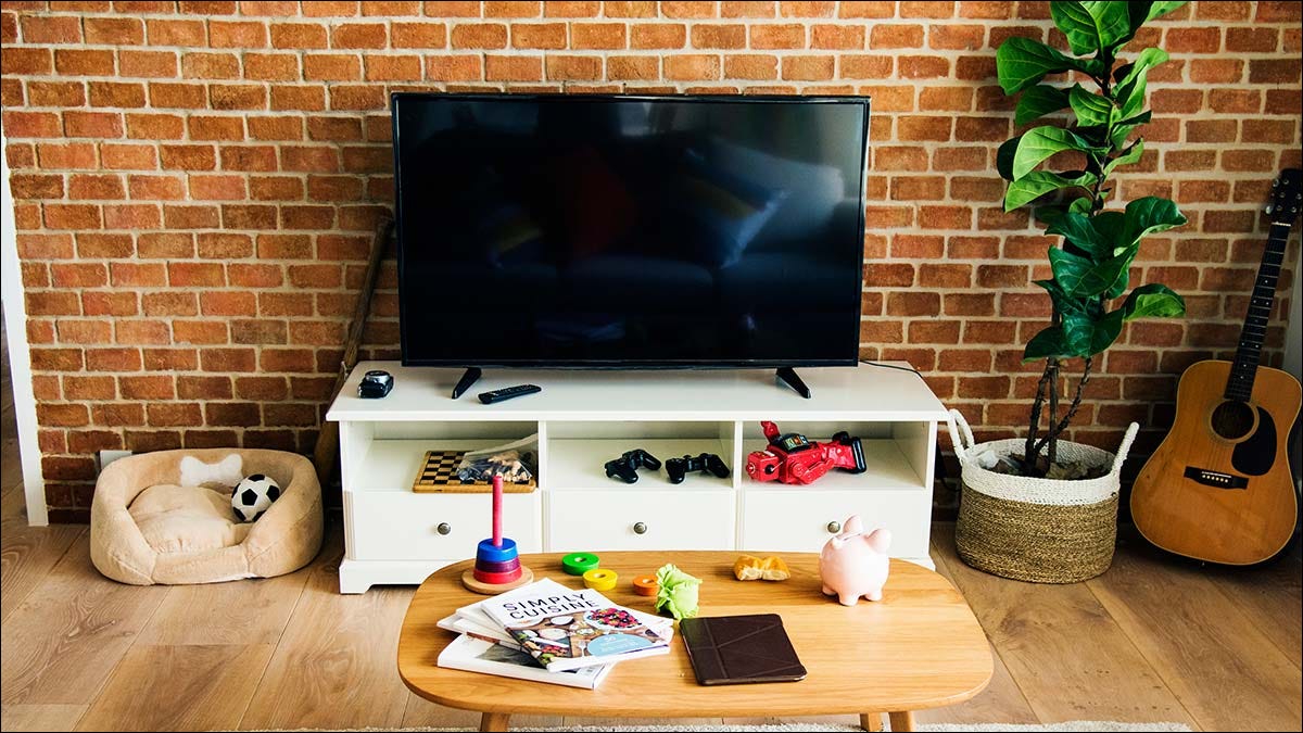 A living room with a TV set on a white console stand.