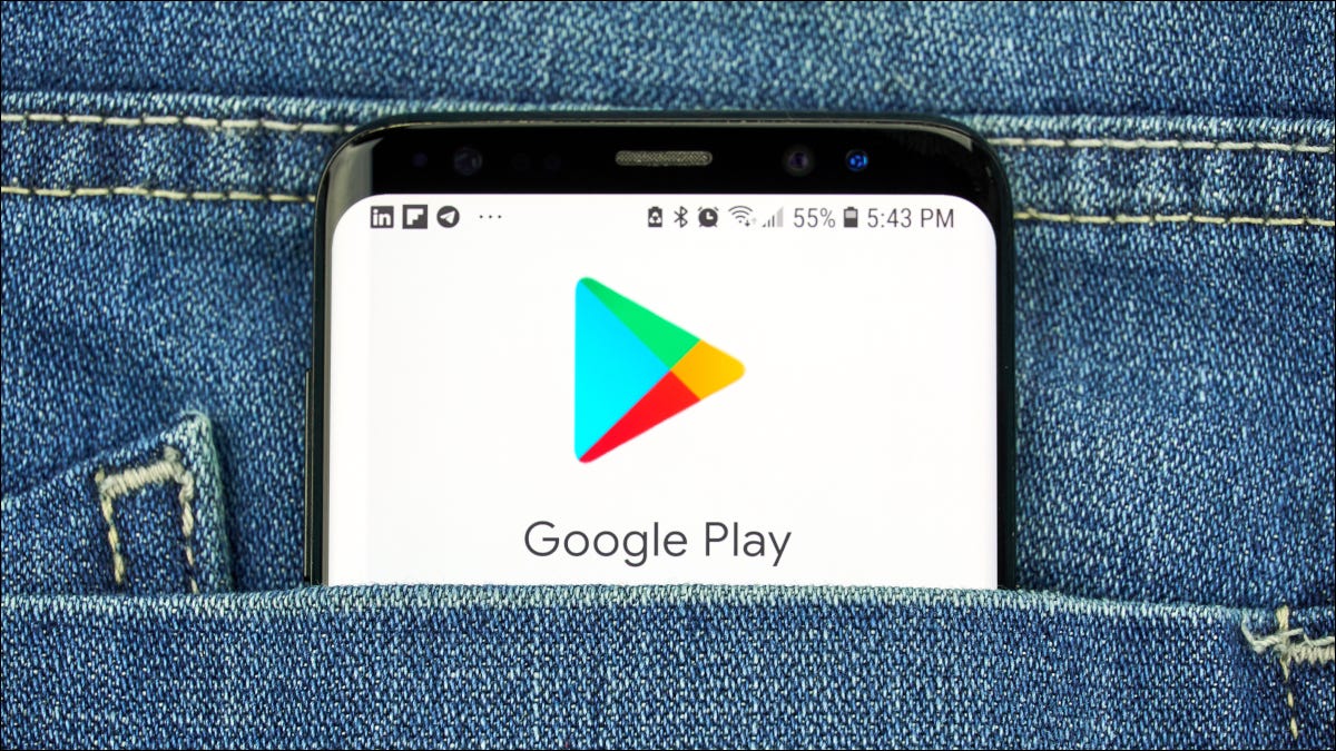 Parte superior de um smartphone no bolso do jeans de uma pessoa, mostrando o logotipo do Google Play.