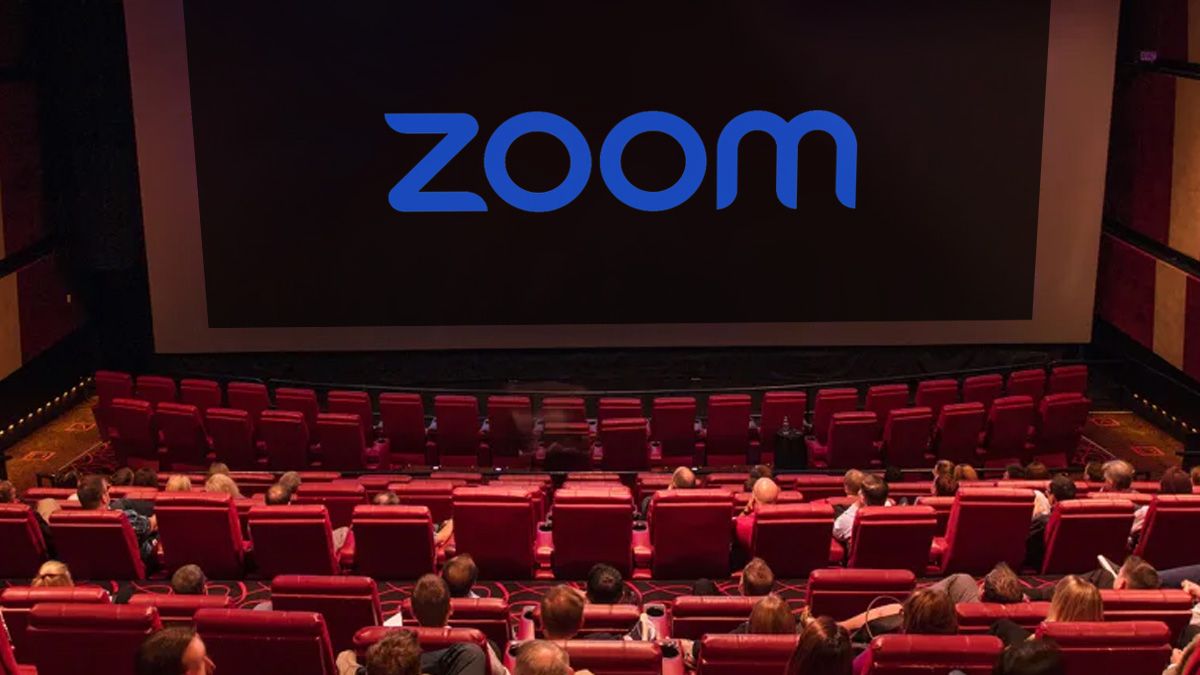 Uma foto de uma sala de cinema com um grande logotipo do Zoom na tela