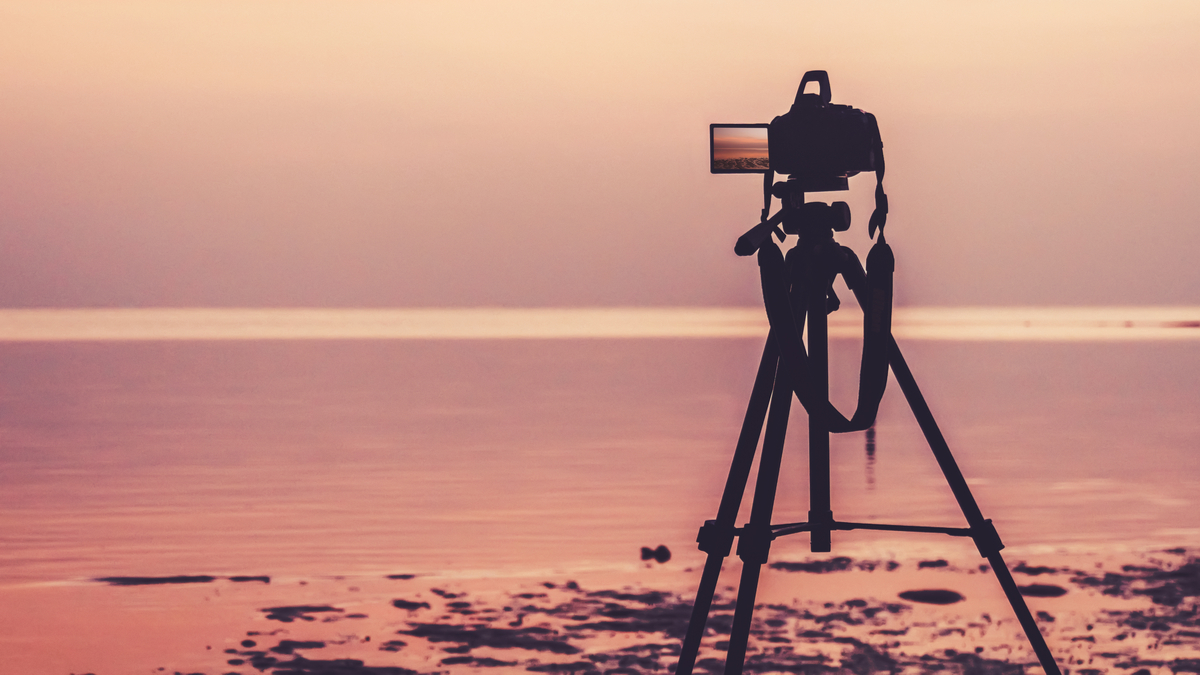 Camera and tripod set up on beach