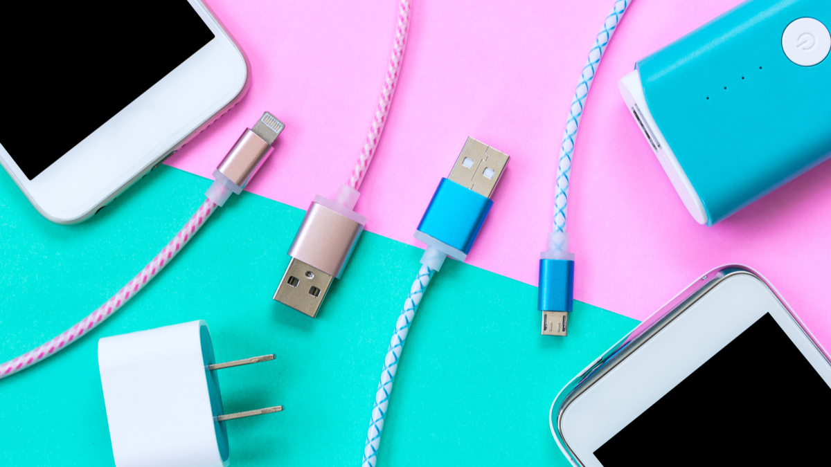 cables, phones, and chargers on a pink and blue background